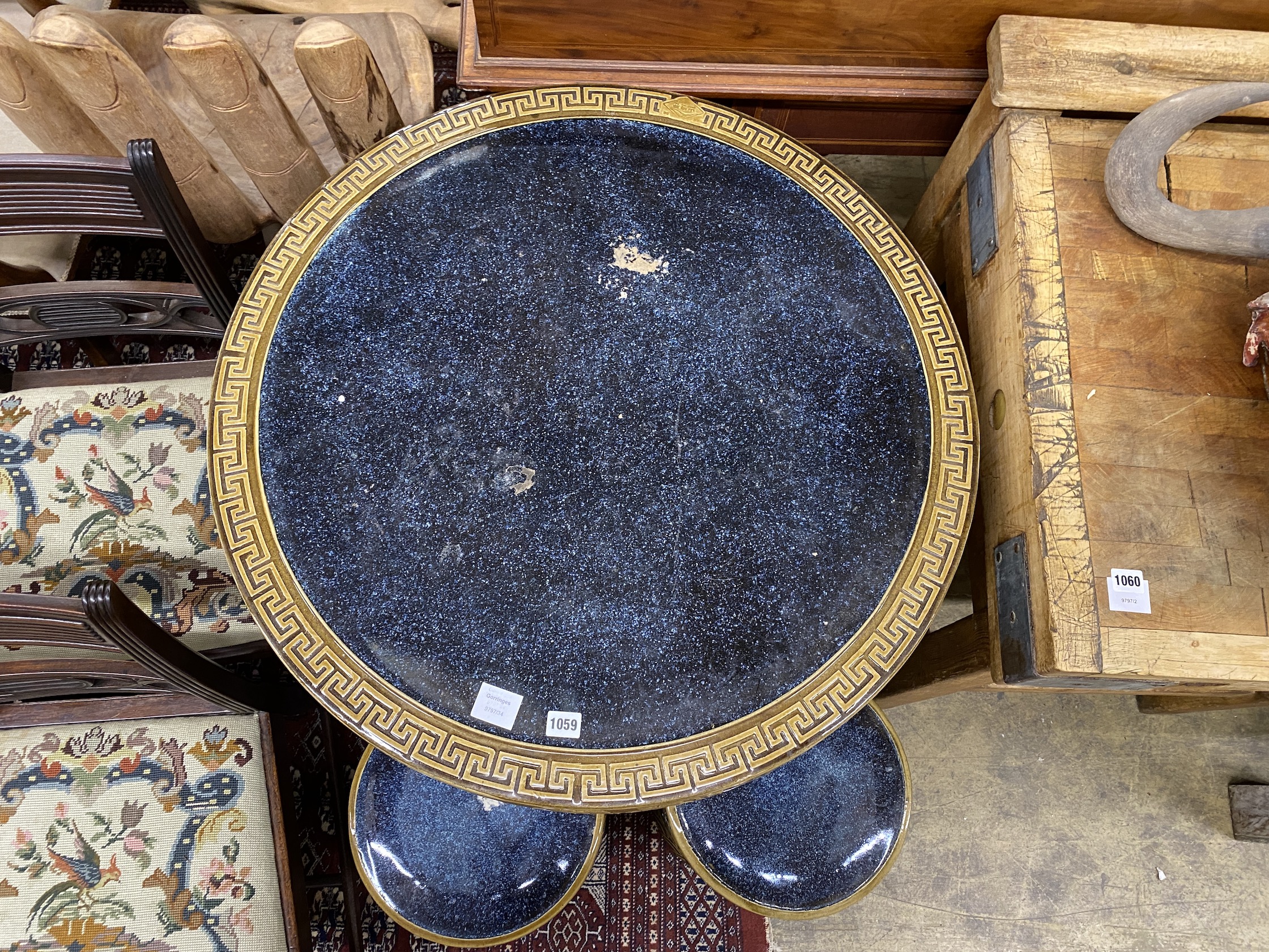 A Chinese style circular glazed earthenware garden table, diameter 80cm, height 76cm and two stools